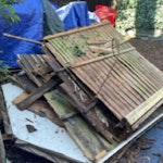 Loose shed panels and branches remnants of a medium sized shed. wood with some screws and nails. some vines and a few broken slabs SE21 - removed for £214