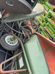 Outdoor swing chair, tr Outdoor swinging chair, tree logs, broken pieces of concrete, plastic chairs, 2 broken wheel barrows, armor cable , outdoor glass table, wooden gate, some oil HA8 - removed for £117