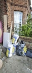 9 Sacks, correx and wood 9 rubble sacks (mainly old lining paper, some general rubble), a few correx sheets, some old skirting and ply/plasterboard offcuts NW2 - removed for £104