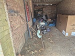 Garage junk and fly tipping Old wheelbarrow, wood, shelving, plastic plant pots, artificial Xmas tree, plastic roll of fencing, old garden furniture, dumped armchair, bags of leaves TW19 - removed for £214