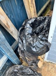 Concrete, soil and wood Broken down pieces of wood and bags of soil we have put there, the concrete was left by the previous owner of our home and was never cleared. NN7 - removed for £94
