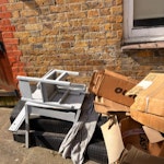 cardboard boxes and chair empty cardboard boxes, a broken kids table and chair and two wooden wheelchair ramps. N12 - removed for £130