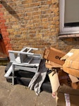 cardboard boxes and chair empty cardboard boxes, a broken kids table and chair and two wooden wheelchair ramps. N12 - removed for £130