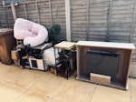 brown bin and house junk Brown bin with garden waste plus some rubbish, random house junk such a small furniture items, picture frame, wicker room divider, small cat house, plant stand, hiking boots, fake plant, body pillow, etc. ST16 - removed for £258