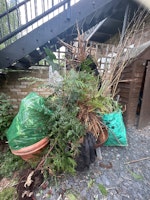 Pile of wood and garden waste collected by Abel Building Ltd