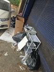 household waste mostly clothes ,2 rubbish bags ,one small wooden desk and 1 cardboard box N22 - removed for £156