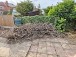 Branches twigs broken fencing A pile of garden waste consisting of cleared tree branches, twigs, and broken wooden fencing panels/timber posts (as shown in the photo). Safe and clear access to the garden for loading. DE23 - removed for £208