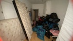 household rubbish 30 bags, bed half in garden from roadside access- cupboard kids garden toys, tonne bag of 2x xl rugs. broken up wood& table electronic tvs, desk. in front access 30 bin liners of house hold waste, gaming chair. single mattress, large double bed frame dismantled w/ head board. broken up wardrobe, multiple empty big boxes, lawnmower in box. bin & hoover. HA1 - removed for £400