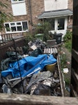 Multiple bin bags etc Multiple bin bags, plastic garden sofa and chair, miscellaneous surrounding rubbish on small decking area and old swimming pool SS16 - removed for £280