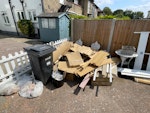 Loose cardboard, wood, tiles Loose pile of cardboard, timber off cuts and come rubble/tiles and general waste. There is also a large glass/wooden door to dispose and a large mirror. The white table and chairs in the photo are not included - they are to remain E18 - removed for £130
