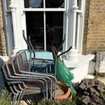 Garden rubbish Water butt, garden table (broken down), 4 garden chairs. Broken plant pots, 2 broken tools, garden patio stones, bag of wooden slats. Basically everything from the green water butt up to and including the blue bin. Also paving slab behind the bins. Maybe the patio stones are reusable? E9 - removed for £257