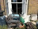 Garden rubbish Water butt, garden table (broken down), 4 garden chairs.  Broken plant pots, 2 broken tools, garden patio stones, bag of wooden slats.  Basically everything from the green water butt up to and including the blue bin.  Also paving slab behind the bins.  Maybe the patio stones are reusable? E9 - removed for £257