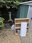 household rubbish & cardboard A lot of cardboard and polystyrene, a small shelf (assembled), large shelf (disassembled), a metal fire brazier, misc household rubbish. SE4 - removed for £130