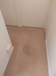 Water damaged hallway carpet. Carpet needs uplifting and removing, along with thick underlay, securing wooden batons and tacks. Carpet is l- shaped, approximately 2.5 metres at widest point, 3.5 metres long. Has two wet patches, from underfloor leak. SG15 - removed for £184