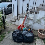 2 bags/ladder/brooms/2 buckets Bag 1 (red tag) contains: box of blades/sharps, caddy with batteries+print cartridges, metal. Could be recycled?
Bag 2 contains general household rubbish
Red bucket with various old brooms
Old watering can
Metal ladder SE10 - removed for £43
