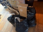 Cardboard and rubbish bags flattened cardboard packaging and 8 tied black bags of general household waste. The waste is currently stored indoors on the ground floor with easy access to parking. TW2 - removed for £83