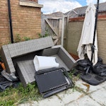 Garden furniture and rubbish Rattan sofa large parasol a bike a sun chair and just some other bits of rubbish in black bags DA12 - removed for £165