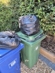 black bags GREEN bin pictured contains black bags that need to be collected.

plus the two additional black bags pictured SL5 - removed for £57