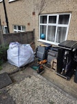 Builders bag, furniture & TV 1 x full builders bag (garden shed waste and some green waste), sofa bed, garden chairs, lawnmower, TV stand and 42" TV, printer, few boxes. All placed outside in the back garden. W5 - removed for £214