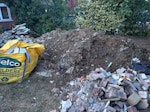 Bricks, concrete & rubble building waste clearance from rear garden now in front. Approx. 4 separate piles consisting of broken bricks/blockwork, concrete garage roof slabs, rubble/spoil and some steel reinforcement. Please quote for all labour, loading, removal and disposal. Photos show the full amount. HA0 - removed for £371