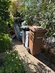 fencing, household, wheelibins wood and metal waste from fencing, broken garden chairs,redundant wheelie bins with garden plastic inside, household waste wood and a suitcase E8 - removed for £130