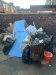 renovation waste wooden boards, a metal fire pit, bagged rubbish, a bath, cardboard and buckets PR5 - removed for £314
