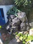 Bags of rubbish from a garden Bags of rubbish, an old chair and clothes drying rack. Mostly not very heavy and all bagged up and stacked in the front garden so easy to collect. SE14 - removed for £194