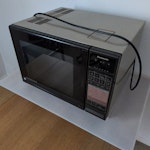Combination microwave Freestanding combination microwave oven, weighs 31Kg. On a table just inside front door EN7 - removed for £192