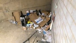 Rubbish removal in basement. There's old paperwork in folders and diaries, old slips in boxes, empty boxes, old drinks machine, old microwave, storage boxes and lots of assortment of rubbish on the floor paper, collection of old posters.
Shop 1291 - HALO0009381 NN8 - removed for £373
