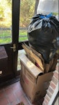 packing boxes and wood items packing boxes, bag of mostly plastic packing rubbish, 1ikea glass door, 2 small white shelving units (1 pictured), table top and leg RG42 - removed for £117