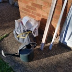 Slate chips and shed junk Fairly small batch: 4 third full jute sacks of slate chips. One small half full box of slate chips. These could possibly be re- used. The rest of batch in picture outside the door. One old curtain track, one old plastic blind. One old plastic jug. Empty cardboard plant delivery box. Bag containing long cuffed gardening gloves. Plastic watering can. SG15 - removed for £104
